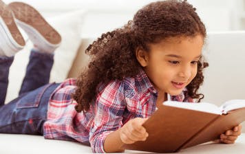 A 5-year-old practises reading to improve her fluency