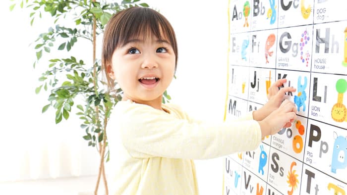 Reception child learning letters and their sounds.