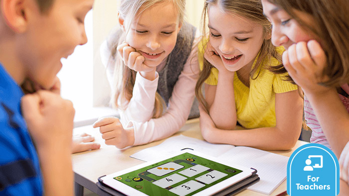 Preschoolers looking down at a digital screen learning how to count